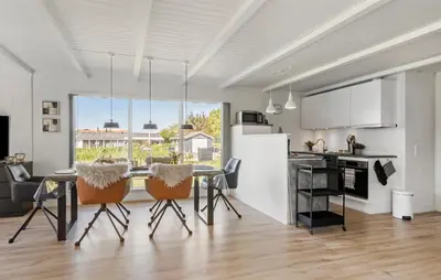 a kitchen and dining room with a table and chairs at 3 Bedroom Cozy Home In Vinderup in Vinderup