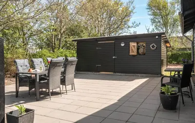 a patio with a table and chairs and a shed at 3 Bedroom Cozy Home In Vinderup in Vinderup
