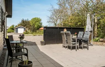 a patio with a table and chairs and an umbrella at 3 Bedroom Cozy Home In Vinderup in Vinderup