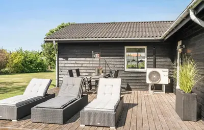 a patio with chairs and a table and a fan at 3 Bedroom Cozy Home In Vinderup in Vinderup