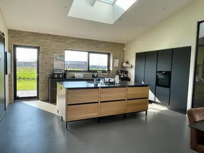 a kitchen with a large island in the middle at Moderne bynært hus in Holstebro