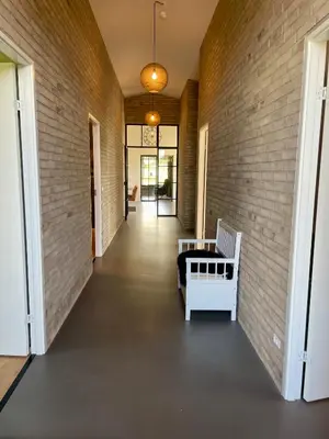 a hallway of a house with a brick wall at Moderne bynært hus in Holstebro