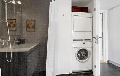 a washer and dryer in a bathroom with a shower at Gorgeous Home In Brovst With Sauna in Brovst
