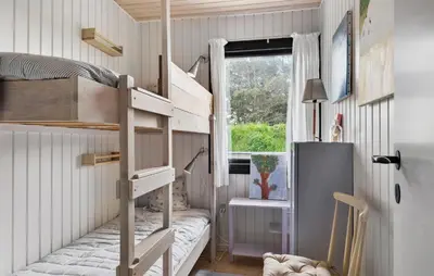 a small room with bunk beds and a window at 4 Bedroom Cozy Home In Saltum in Saltum