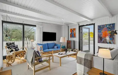 a living room with a blue couch and chairs at 4 Bedroom Cozy Home In Saltum in Saltum