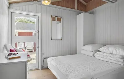 a white bedroom with a bed and a window at 3 Bedroom Beautiful Home In Blokhus in Blokhus