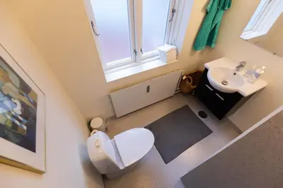an overhead view of a bathroom with a toilet and sink at Lejlighed i Holstebro gågade in Holstebro