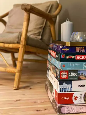a stack of books sitting on the floor next to a chair at Cozy big apartment in Blokhus