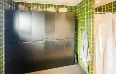a bathroom with green tiled walls and a shower stall at Cozy Home In Thyborøn With Wifi in Thyborøn