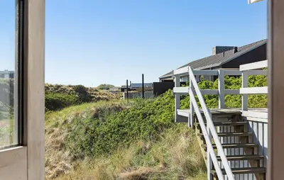 a stairway leading up to a house with a window at Stunning Home In Blokhus With Wifi in Blokhus