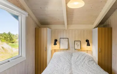 a bedroom in a tiny house with a window at 3 Bedroom Beautiful Home In Blokhus in Blokhus