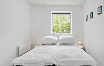 a white bedroom with a large bed and a window at 3 Bedroom Stunning Home In Spøttrup in Spottrup