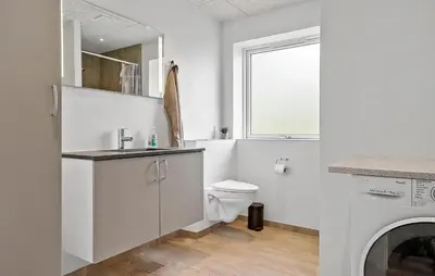 a white bathroom with a toilet and a sink at 3 Bedroom Stunning Home In Spøttrup in Spottrup