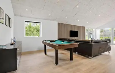 a living room with a pool table and a couch at 3 Bedroom Stunning Home In Spøttrup in Spottrup