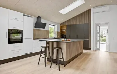 a kitchen with a island with bar stools in it at 3 Bedroom Stunning Home In Spøttrup in Spottrup