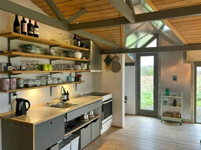 a kitchen with a sink and a counter top at Summer House With Fields And Fjord Views in Thyholm