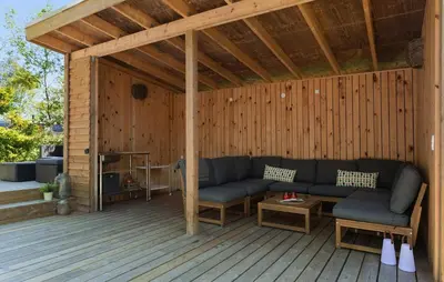 a patio with a couch and a table on a wooden deck at Beautiful Home In Fur With Wifi in Fur