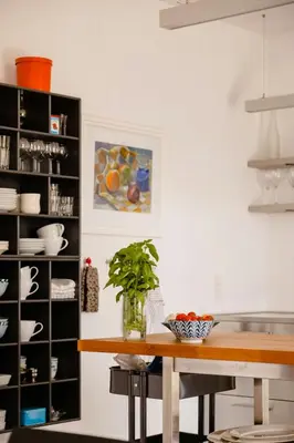 a kitchen with a table and a shelf with dishes at Lovely House Near Nature For Relaxation in Fjerritslev