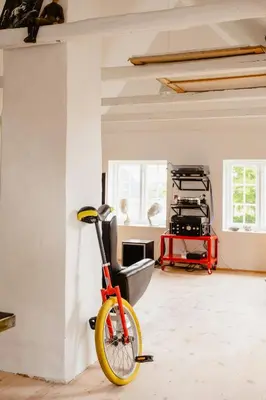 a bike parked in a room with a wall at Lovely House Near Nature For Relaxation in Fjerritslev