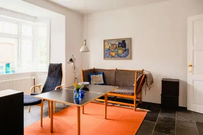 a living room with a table and chairs at Lovely House Near Nature For Relaxation in Fjerritslev