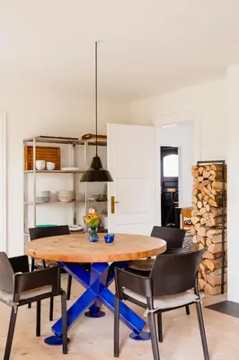 a dining room with a wooden table and chairs at Lovely House Near Nature For Relaxation in Fjerritslev
