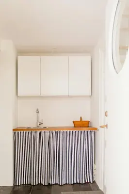 a kitchen with a counter with a sink and white cabinets at Lovely House Near Nature For Relaxation in Fjerritslev