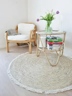a coffee table with books on it next to a chair at Modern House Close To The North Sea in Tranum