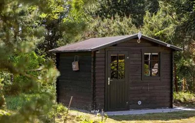 a small shed with a window and a door at 3 Bedroom Stunning Home In Blokhus in Blokhus
