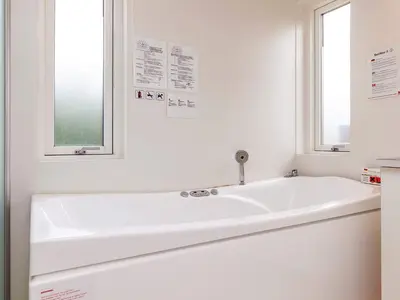 a white bath tub in a bathroom with a window at 4 star holiday home in Brovst in Brovst