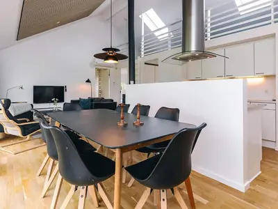 a dining room with a black table and chairs at 4 star holiday home in Brovst in Brovst