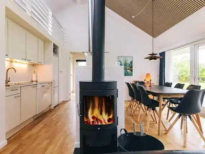 a kitchen and dining room with a fireplace in a house at 4 star holiday home in Brovst in Brovst