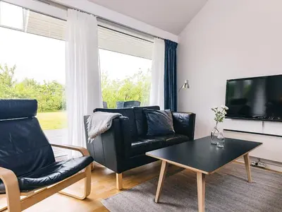 a living room with a couch and a table and a tv at 4 star holiday home in Brovst in Brovst