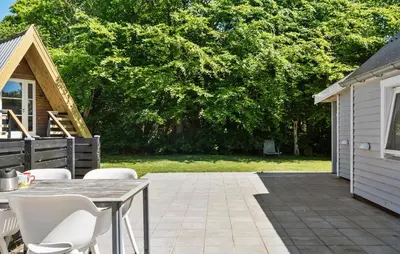 a patio with a table and chairs in a yard at Stunning Home In Vemb With Wifi in Vemb