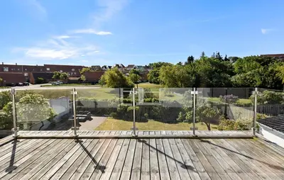 a wooden deck with a view of a park at Nice Home In Løgstør With Wifi in Løgstør