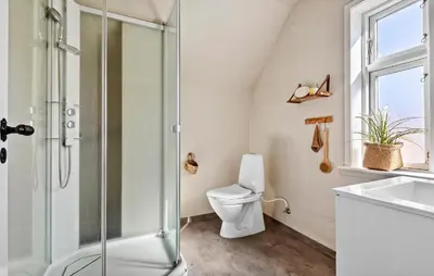 a bathroom with a shower and a toilet and a sink at Nice Home In Løgstør With Wifi in Løgstør