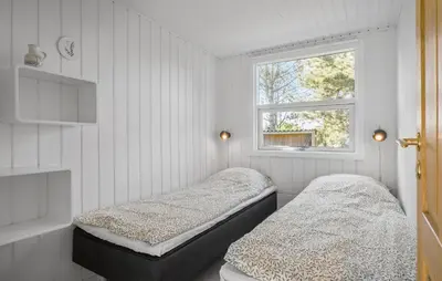 two beds in a room with a window at Stunning Home In Saltum With Wifi in Saltum