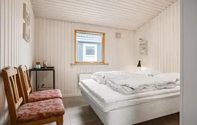 a white bedroom with a bed and a chair at 3 Bedroom Beautiful Home In Thisted in Thisted