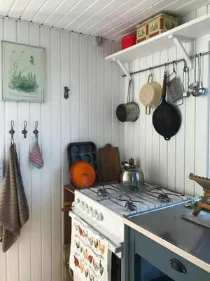 a kitchen with a stove top oven next to a counter at Cozy Wagon House With Views Over The Limfjord in Roslev