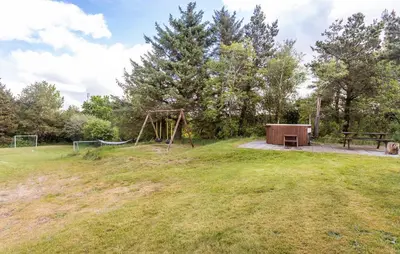 a park with a playground with a bench and a picnic table at Gorgeous Home In Hurup Thy With Wifi in Sønder Ydby