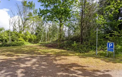 a parking sign next to a dirt road with trees at Gorgeous Home In Hurup Thy With Wifi in Sønder Ydby