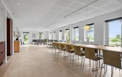 a dining room with a long table and chairs at Gorgeous Home In Hurup Thy With Wifi in Sønder Ydby