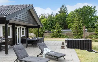 a patio with chairs and a table and a grill at 3 Bedroom Cozy Home In Højslev in Højslev