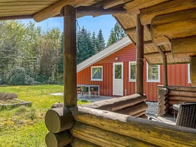 a view of a cabin from the porch of a log house at Holiday Home Atti - 500m to the fjord by Interhome in Højslev
