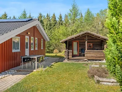 a cabin with a table and chairs in the yard at Holiday Home Atti - 500m to the fjord by Interhome in Højslev