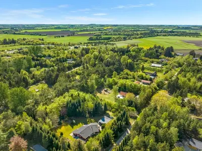 an aerial view of a farm with a house and trees at Holiday Home Atti - 500m to the fjord by Interhome in Højslev