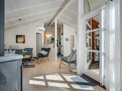 a living room with a table and chairs at Holiday Home Atti - 500m to the fjord by Interhome in Højslev