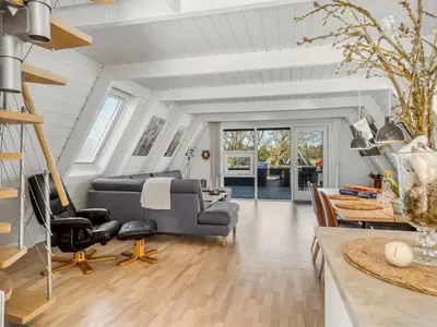a living room with a couch and a table at Apartment Kauno - 16km to the fjord by Interhome in Farsø