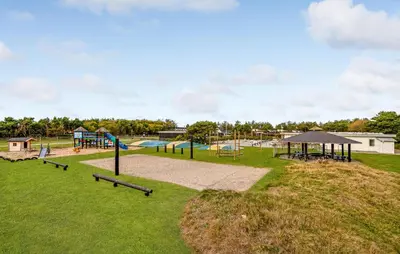 a park with a playground with slides and swings at 5 Bedroom Awesome Home In Vestervig in Vestervig