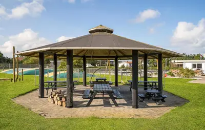 a gazebo with benches and tables in a park at 5 Bedroom Awesome Home In Vestervig in Vestervig