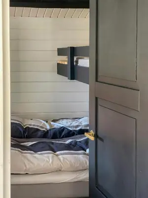 an open door to a bed in a room at Traditional Summer House Near Blokhus Beach in Blokhus